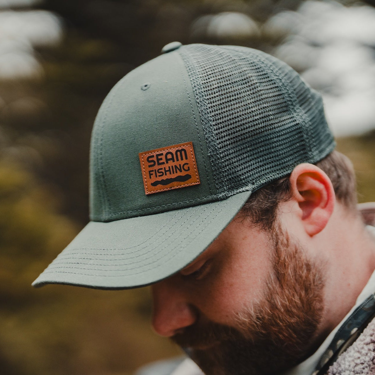 Person wearing a branded fishing hat