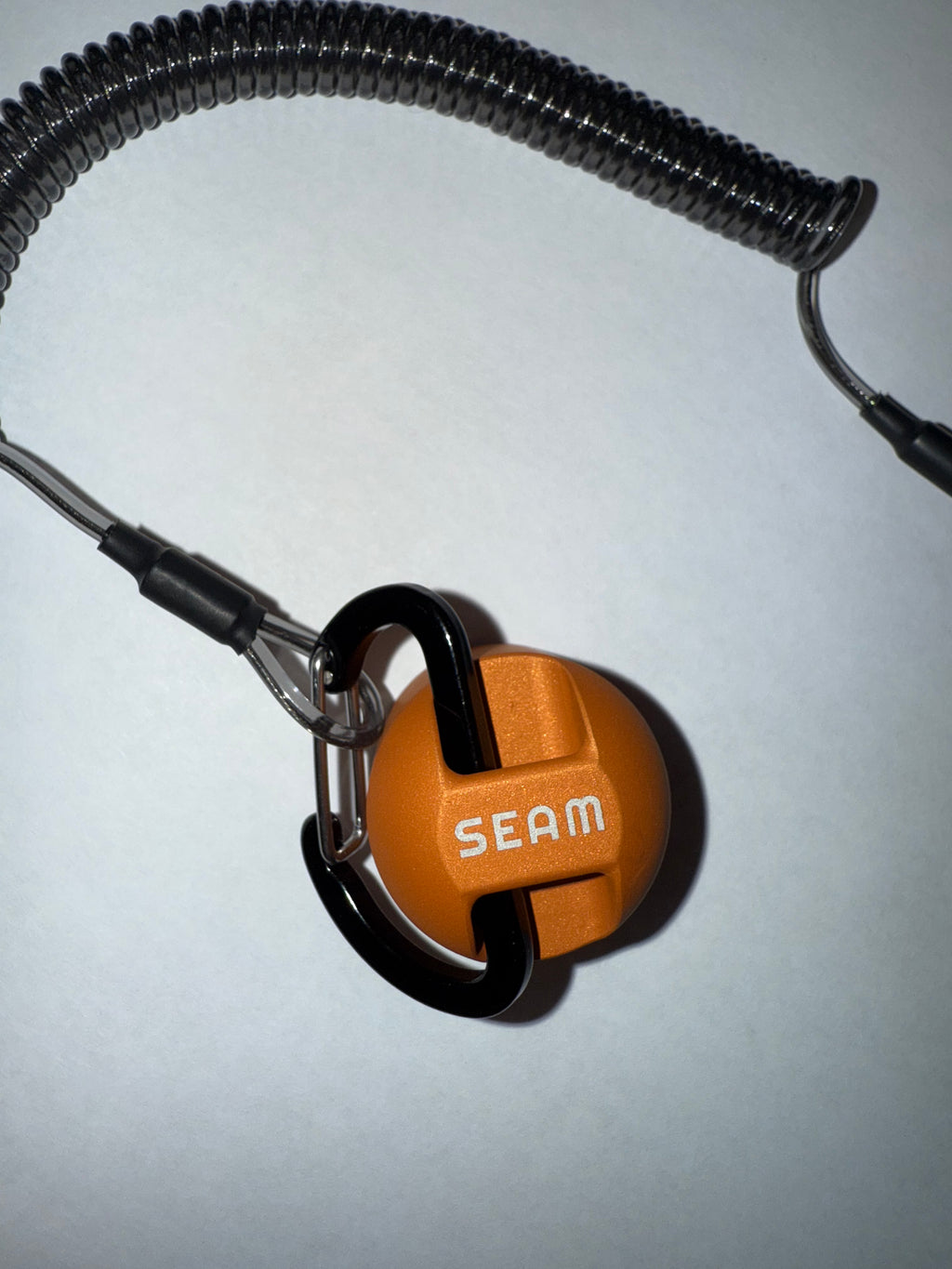 Orange lanyard end with metal clip on a white background (global)