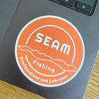 SEAM Fishing logo sticker on a laptop (global)