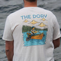 Person wearing a t-shirt with 'The Dory' design by a body of water (global)