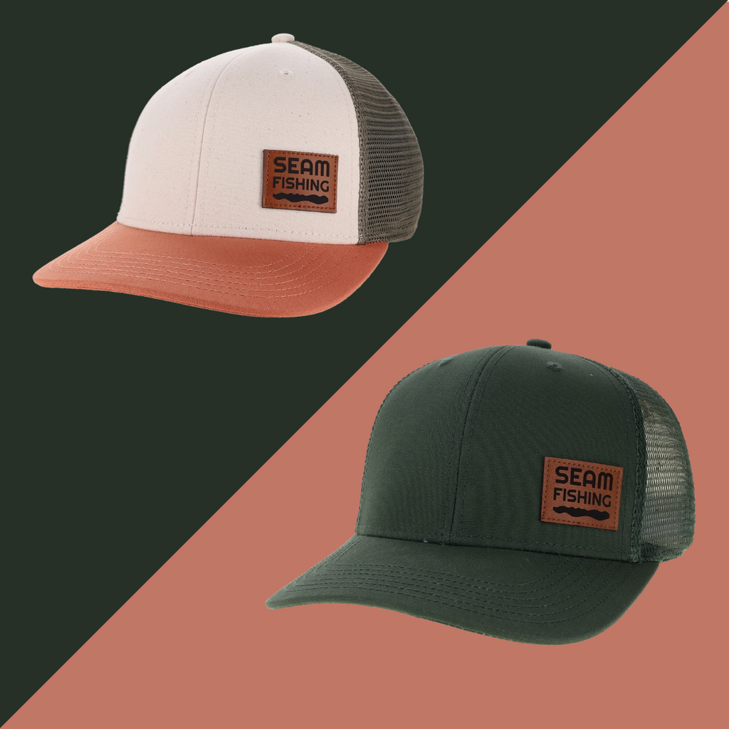 Two caps with 'Seam Fishing' logo on a black and brown gradient background (global)